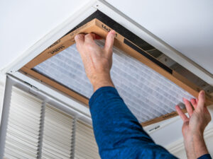 Man replacing dirty HVAC air filter